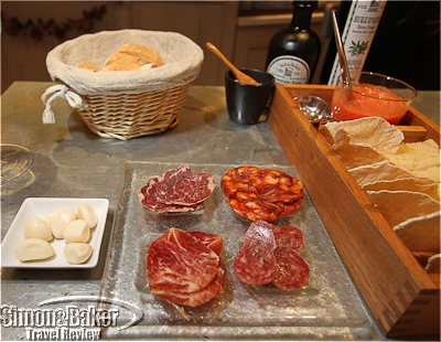 A selection of Spanish pork products with crackers and homemade tomato dip