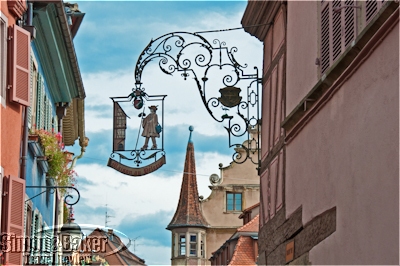 Antique wrought iron signs are still a common sight in Colmar