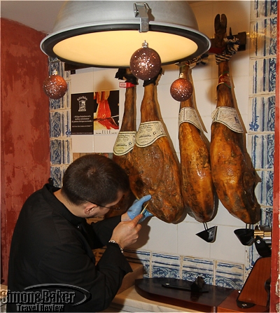 The staff demonstrated piercing the ham to check the curing