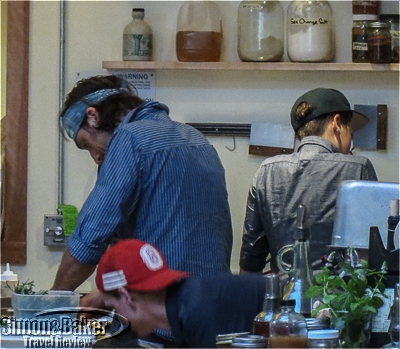 The open kitchen allows diners to watch the chef at work