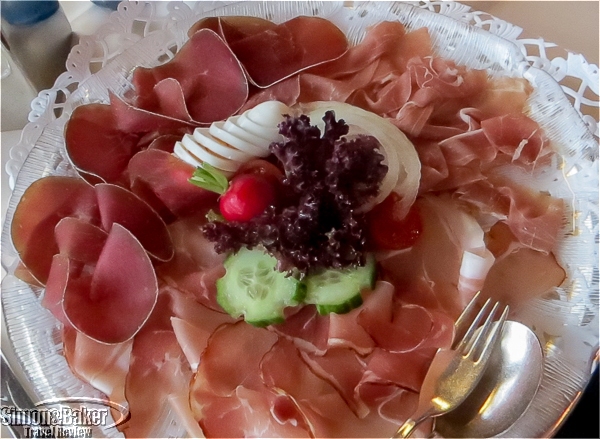 A plate of black forest hams and sausage