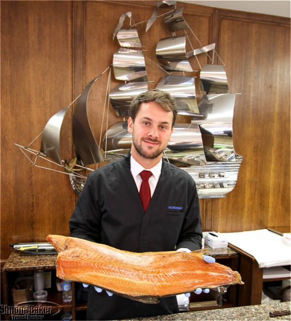 Phillipe displays a smoked salmon before slicing